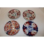 Four 19th century Japanese Imari pottery circular shallow bowls with painted floral decoration