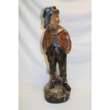 A 1930's painted plaster figure of a young boy,