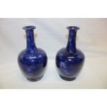 A pair of Royal Doulton pottery blue glazed tapered spill vases with raised leaf decoration 8½"