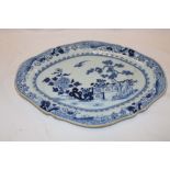 An 18th century Chinese oval platter with blue and white floral and landscape decoration,