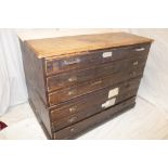 An old mahogany and beech rectangular plan chest with six shallow drawers on plinth base,