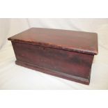 A 19th century stained pine miniature trunk/blanket box with internal candle fitment enclosed by a