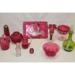 A selection of various cranberry tinted glassware including vases,