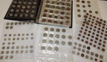 An album containing a large selection of mixed coins including GB coins, silver 3ds,