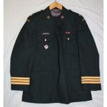 A Canadian Royal Westminster Regiment green tunic with brass buttons and badges and accompanying