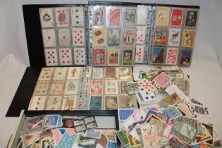Three albums containing single examples of playing cards including numerous advertising examples -