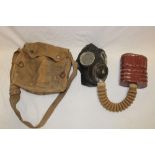 A Second War military gas mask in canvas carrier