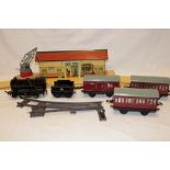 Hornby 0 gauge - a type 50 clockwork locomotive and tender, three tin-plate carriages,