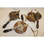 Four various Mine Surveyor's steel tapes including 100 feet steel tape with brass frame and turned