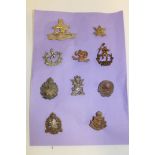 A selection of various Colonial and Military cap badges including Bloemfontein Regiment,