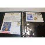 An album containing a selection of medallic postal covers including 1991 USA silver eagle dollar