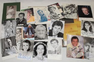 A selection of signed celebrity postcards and an album of various cigarette adverts,