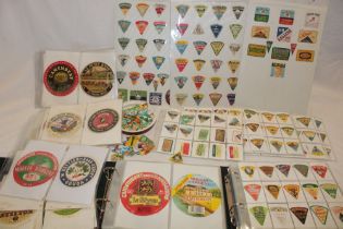 Two albums containing a collection of various cheese labels including large labels,
