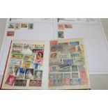 A stock book and album containing a small selection of various World stamps