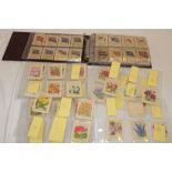 An album of various silk cigarette cards and loose silk cigarette cards including Kensitas flowers,