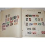 An old German printed album containing a selection of World stamps,