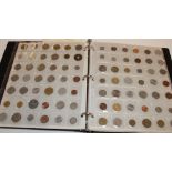 An album containing a collection of mixed Foreign coins including some silver examples