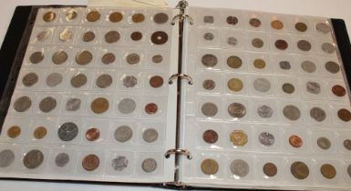 An album containing a collection of mixed Foreign coins including some silver examples