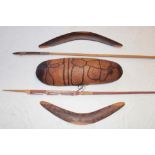 Two Australian aboriginal wood boomerangs, one with incised decoration, a long wooden spear,