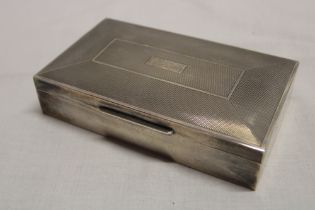 A silver rectangular cigarette box with engine turned hinged lid, Birmingham marks,