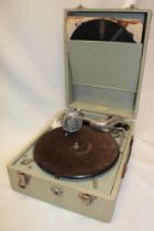 A vintage portable gramophone "The Sonorophone" in chequered fibre case with records