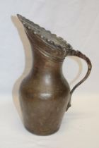An early Middle Eastern copper baluster-shaped jug with loop handle,