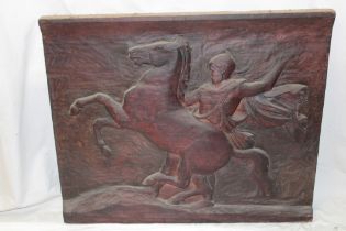 An unusual Continental carved wood rectangular panel depicting a classical figure with horse,