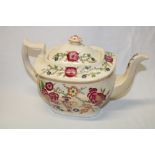 An early 19th century cream glazed rectangular tea pot with painted floral decoration