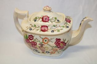 An early 19th century cream glazed rectangular tea pot with painted floral decoration