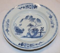 An 18th century Chinese circular shallow bowl with blue and white painted decoration 9" diameter