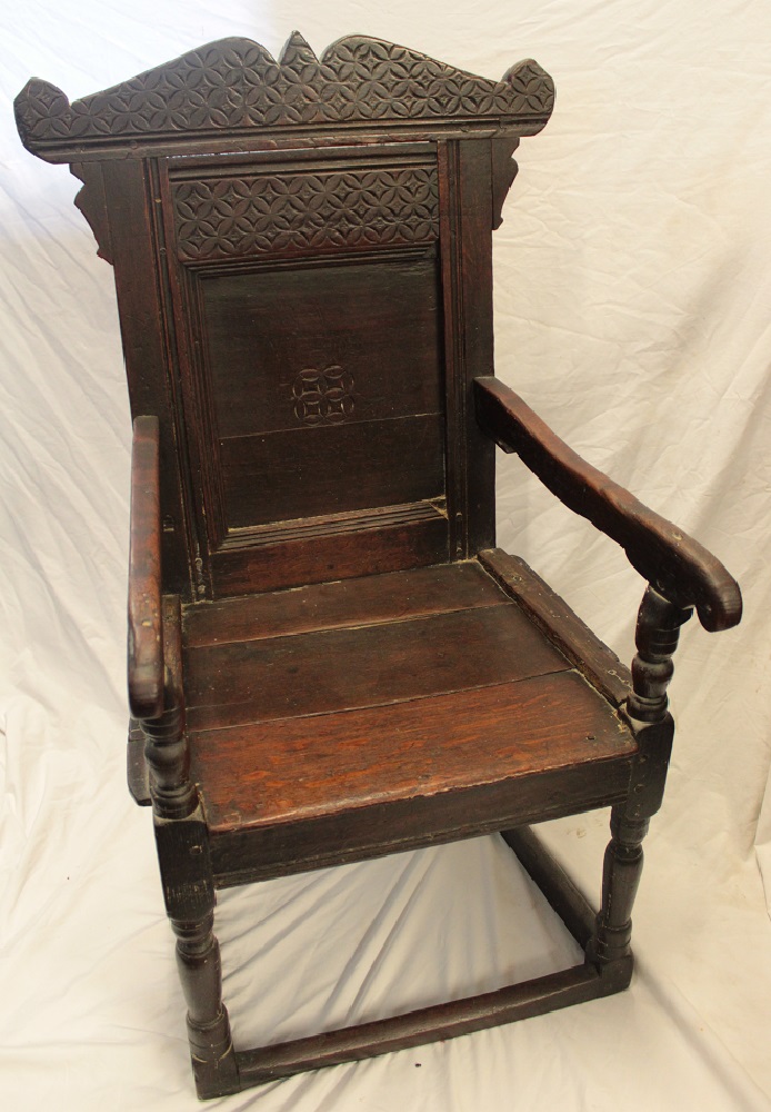 A 17th century carved oak carver armchair with arched panelled back and planked seat on turned - Image 2 of 5