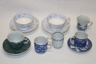 A selection of various Eastern cups and saucers and a pair of Victorian blue and white cups and