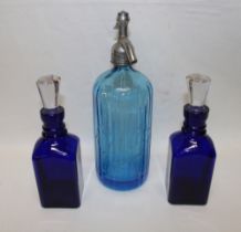 A pair of Bristol blue-tinted glass square decanters with clear faceted stoppers 9" high and a