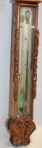 A small late 19th century mercury barometer with silvered decorated panel in carved oak rectangular