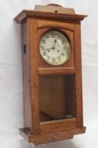 A good quality 1920/30s wall clock with silvered circular dial in polished oak glazed case