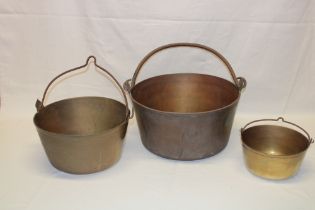 Three 19th century brass graduated circular preserve pans with iron handles, 15" diameter,