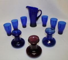 A Bristol blue-tinted glass tapered jug with six matching beakers;
