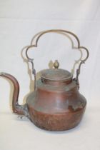 An early 19th century copper and brass kettle with scroll handle