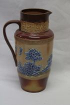 An unusual Doulton Pottery tapered jug with raised blue Willow pattern decoration on brown ground,