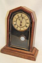 An American mantel clock with painted circular dial in walnut tapered case (af)