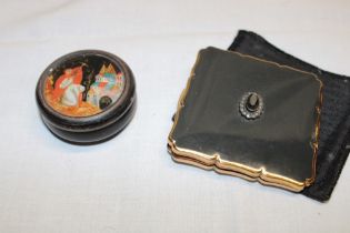 A Russian lacquered circular compact with figure and landscape decoration and one other decorative