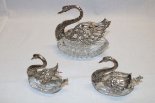A cut-glass and silver mounted swan-shaped condiment bowl with hinged wings and a pair of matching