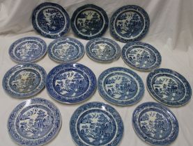 Fourteen various 18th and 19th century pottery circular plates with blue and white 'Willow' pattern