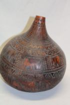 A natural gourd carved all over with elephants and geometric shapes