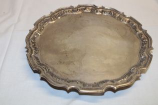 An Eastern sterling silver circular tray with animal and landscape decorated edge,