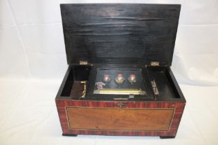 A 19th century Continental music box with brass mounts and three internal bells in walnut and