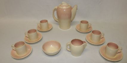 A Susie Cooper china coffee set comprising a tapered coffee pot with pink decoration, milk jug,