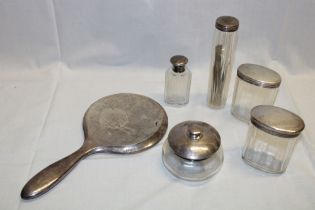 A pair of silver topped oval glass dressing table bottles,