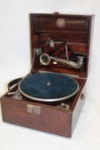 An old portable gramophone by Beltona with chromium plated mounts in oak case