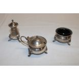 A sterling silver three-piece cruet set comprising lidded mustard pot,